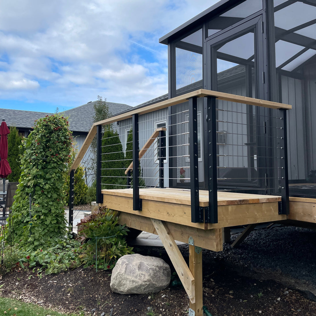 Metal railing with wooden handrail in Wellington Ontario